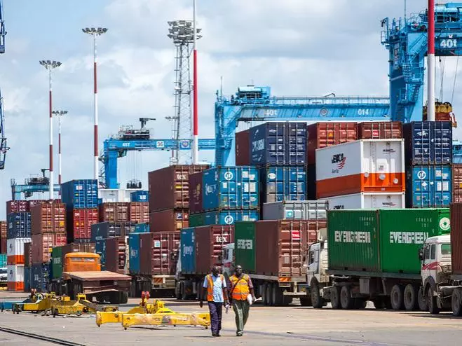 Mombasa's port, with two workers walking in the foreground