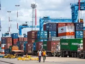 Mombasa's port, with two workers walking in the foreground